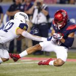 Arizona wide receiver Tayvian Cunningham catches a touchdown in front of Northern Arizona defensive back Anthony Sweeney (12) in the first half during an NCAA college football game, Saturday, Sept. 7, 2019, in Tucson, Ariz. (AP Photo/Rick Scuteri)