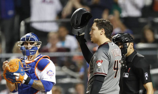 New York Mets' catcher Wilson Ramos, left, watches as Arizona Diamondbacks' Wilmer Flores (41) tips...