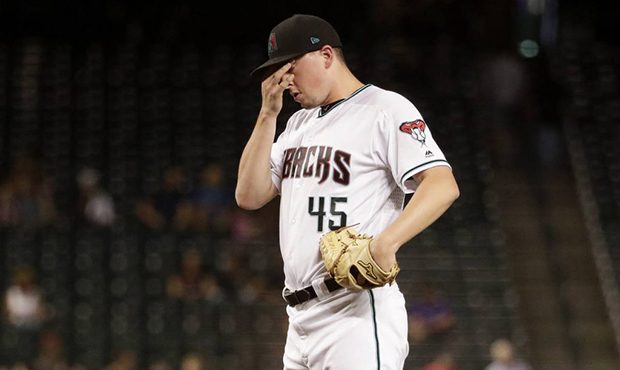 Arizona Diamondbacks pitcher Taylor Clarke pauses after giving up a run to the Miami Marlins during...