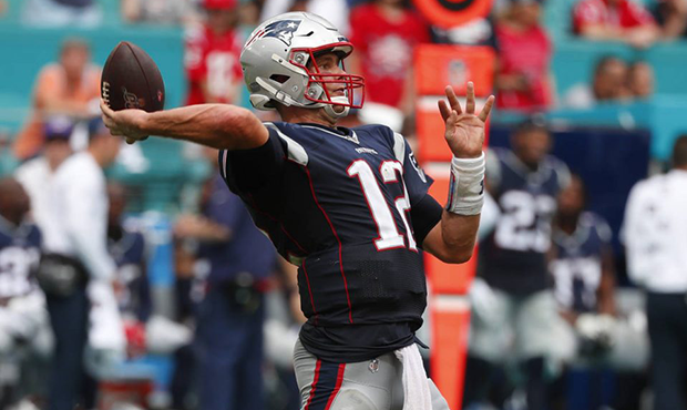 New England Patriots quarterback Tom Brady (12) looks to pass, during the second half at an NFL foo...