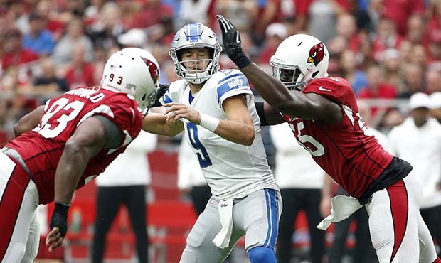 Quarterback Matthew Stafford # 9 of the Detroit Lions is sacked by Chandler Jones #55 of the Arizon...