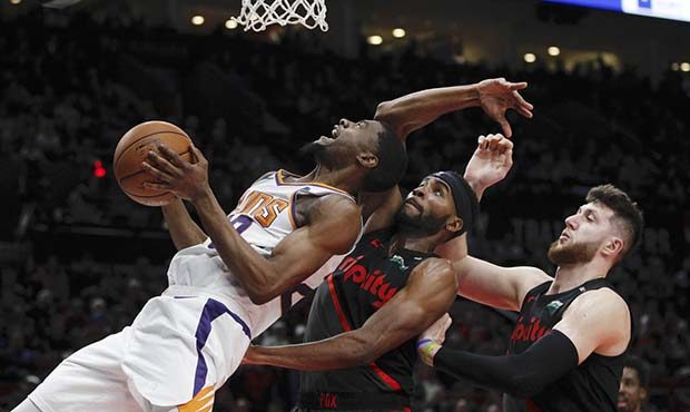 Phoenix Suns forward Josh Jackson, left, prepares to shoot as Portland Trail Blazers forward Mauric...