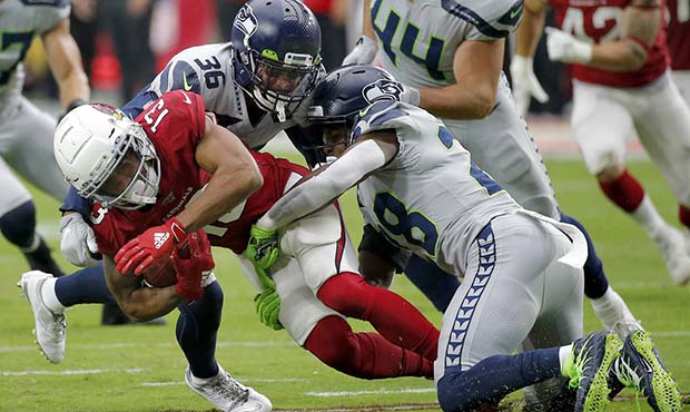 Arizona Cardinals wide receiver Christian Kirk (13) is tackled by Seattle Seahawks cornerback Akeem...