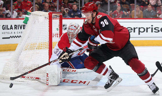 Christian Fischer #36 of the Arizona Coyotes skates with the puck past goaltender Carey Price #31 o...