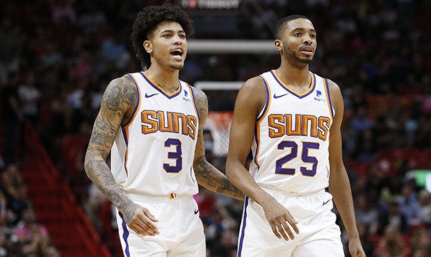 Kelly Oubre Jr. #3 and Mikal Bridges #25 of the Phoenix Suns look on against the Miami Heat during ...