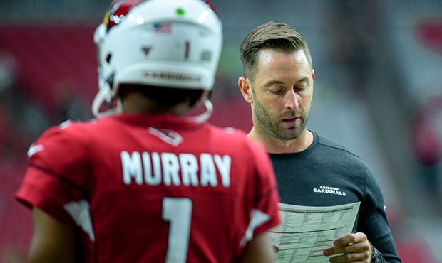 Head coach Kliff Kingsbury of the Arizona Cardinals looks at his play sheet in front of quarterback...