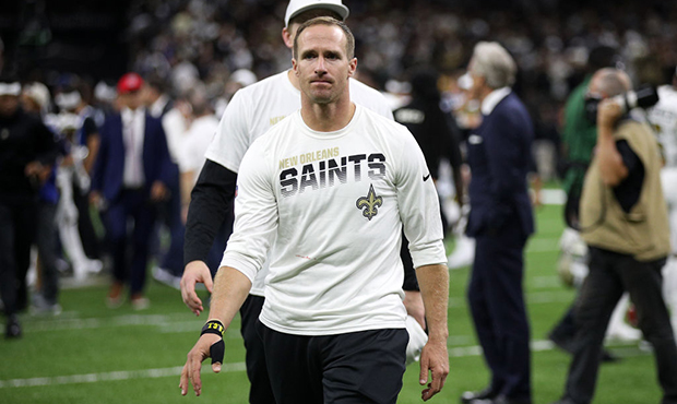Drew Brees #9 of the New Orleans Saints walks off the field holding his thumb after surgery at the ...