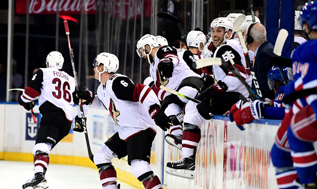 The Arizona Coyotes celebrate after Christian Dvorak #18 scores the game winning over time goal dur...