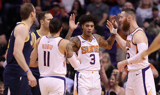 Kelly Oubre Jr. #3 of the Phoenix Suns high fives Ricky Rubio #11 and Aron Baynes #46 during the se...