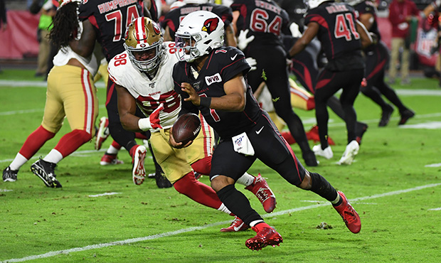 Kyler Murray #1 of the Arizona Cardinals runs with the ball pursued by Ronald Blair III #98 of the ...