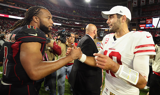 Wide receiver Larry Fitzgerald #11 of the Arizona Cardinals and quarterback Jimmy Garoppolo #10 of ...