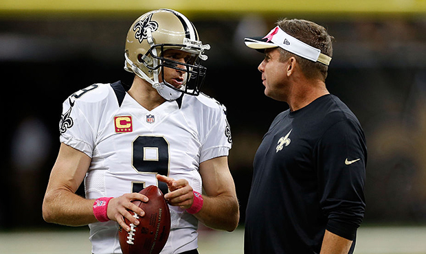 Head coach Sean Payton of the New Orleans Saints speaks with Drew Brees #9 prior to a game against ...