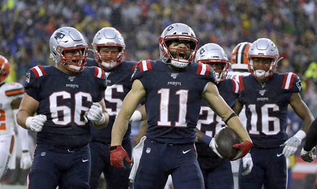 New England Patriots wide receiver Julian Edelman, center, celebrates his touchdown catch with team...