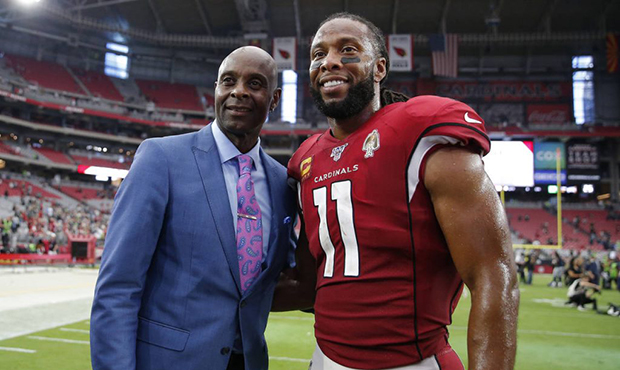 Arizona Cardinals wide receiver Larry Fitzgerald (11) poses with NFL hall of famer Jerry Rice after...