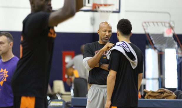Phoenix Suns’, head coach Monty Williams, middle, chats with, guard, Devin Booker during their tr...