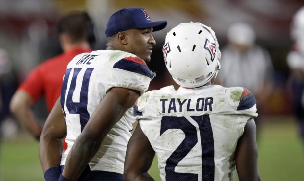 Arizona quarterback Khalil Tate (14) and running back J.J. Taylor watch from the sideline in the cl...