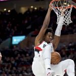 Portland Trail Blazers center Hassan Whiteside dunks in front of Phoenix Suns forward Frank Kaminsky during the first half of a preseason NBA basketball game in Portland, Ore., Saturday, Oct. 12, 2019. (AP Photo/Craig Mitchelldyer)