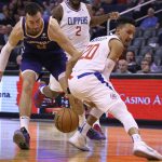 Phoenix Suns forward Frank Kaminsky, left, beats LA Clippers guard Landry Shamet (20) to the loose ball during the second half of a basketball game Saturday, Oct. 26, 2019, in Phoenix. The Suns defeated the Clippers 130-122. (AP Photo/Ross D. Franklin)