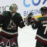 Arizona Coyotes goaltender Antti Raanta, left, celebrates with defenseman Kyle Capobianco (75) as time expires in the third period of an NHL hockey game win against the Ottawa Senators, Saturday, Oct. 19, 2019, in Glendale, Ariz. (AP Photo/Ross D. Franklin)