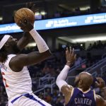 LA Clippers forward Montrezl Harrell, left, shoots over Phoenix Suns guard Jevon Carter, right, during the first half of a basketball game Saturday, Oct. 26, 2019, in Phoenix. (AP Photo/Ross D. Franklin)