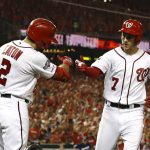 Washington Nationals' Trea Turner, right, celebrates his solo home run with teammate Adam Eaton in the third inning of a National League wild card baseball game against the Milwaukee Brewers, Tuesday, Oct. 1, 2019, in Washington. (AP Photo/Patrick Semansky)