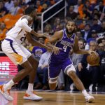 Sacramento Kings guard Cory Joseph (9) drives past Phoenix Suns forward Mikal Bridges during the first half of an NBA basketball game Wednesday, Oct. 23, 2019, in Phoenix. (AP Photo/Rick Scuteri)