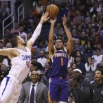 Phoenix Suns guard Devin Booker (1) shoots over LA Clippers center Ivica Zubac (40) during the second half of a basketball game Saturday, Oct. 26, 2019, in Phoenix. The Suns defeated the Clippers 130-122. (AP Photo/Ross D. Franklin)