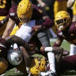 Washington State wide receiver Renard Bell (9) is tackled by Arizona State defensive lineman George Lea (17), linebacker Merlin Robertson (8),  linebacker Tyler Whiley (23) and safety Cam Phillips, bottom, during the first half of an NCAA college football game Saturday, Oct. 12, 2019, in Tempe, Ariz. (AP Photo/Ross D. Franklin)