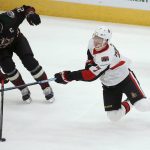Arizona Coyotes defenseman Oliver Ekman-Larsson (23) pokes the puck away from Ottawa Senators left wing Brady Tkachuk (7) during the first period of an NHL hockey game Saturday, Oct. 19, 2019, in Glendale, Ariz. (AP Photo/Ross D. Franklin)