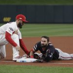 St. Louis Cardinals' Matt Carpenter puts a late tag on Washington Nationals' Adam Eaton after his triple during the seventh inning of Game 1 of the baseball National League Championship Series against the St. Louis Cardinals Friday, Oct. 11, 2019, in St. Louis.(AP Photo/Mark Humphrey)