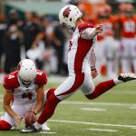 Arizona Cardinals kicker Zane Gonzalez (5) boots an extra point alongside placeholder Andy Lee (4) in the first half of an NFL football game against the Cincinnati Bengals, Sunday, Oct. 6, 2019, in Cincinnati. (AP Photo/Gary Landers)