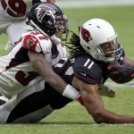 Arizona Cardinals wide receiver Larry Fitzgerald (11) is hit by Atlanta Falcons free safety Ricardo Allen (37) during the second half of an NFL football game, Sunday, Oct. 13, 2019, in Glendale, Ariz. (AP Photo/Ross D. Franklin)
