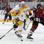 Nashville Predators defenseman Dan Hamhuis (5) and Arizona Coyotes right wing Michael Grabner (40) vie for the puck during the second period of an NHL hockey game Thursday, Oct. 17, 2019, in Glendale, Ariz. (AP Photo/Rick Scuteri)