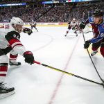 Colorado Avalanche left wing Andre Burakovsky (95) passes the puck past Arizona Coyotes center Carl Soderberg (34) during the first period of an NHL hockey game, Saturday, Oct. 12, 2019, in Denver (AP Photo/Jack Dempsey)