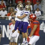 Washington wide receiver Aaron Fuller (2) celebrates with Cade Otton after scoring a touchdown against Arizona in the second half during an NCAA college football game, Saturday, Oct. 12, 2019, in Tucson, Ariz. (AP Photo/Rick Scuteri)