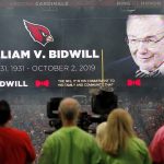 Fans pause for a moment of silence in memory of the late Arizona Cardinals owner William V. Bidwill prior to NFL football game against the Atlanta Falcons, Sunday, Oct. 13, 2019, in Glendale, Ariz. (AP Photo/Ross D. Franklin)