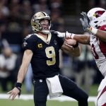 New Orleans Saints quarterback Drew Brees (9) is pressured by Arizona Cardinals defensive end Jonathan Bullard (90) after releasing the ball in the first half of an NFL football game in New Orleans, Sunday, Oct. 27, 2019. The Saints won 31-9. (AP Photo/Butch Dill)