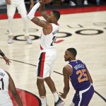 Portland Trail Blazers guard Kent Bazemore (24) shoots in front of Phoenix Suns forward Mikal Bridges (25) during the first half of a preseason NBA basketball game in Portland, Ore., Saturday, Oct. 12, 2019. (AP Photo/Craig Mitchelldyer)