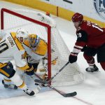 Nashville Predators goaltender Juuse Saros makes the save on a shot by Arizona Coyotes left wing Christian Dvorak (18) as Colton Sissons (10) defends in the first period during an NHL hockey game, Thursday, Oct. 17, 2019, in Glendale, Ariz. (AP Photo/Rick Scuteri)