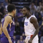LA Clippers guard Patrick Beverley jaws with Phoenix Suns guard Devin Booker, left, after a Booker score during the second half of a basketball game Saturday, Oct. 26, 2019, in Phoenix. The Suns defeated the Clippers 130-122. (AP Photo/Ross D. Franklin)