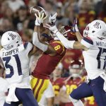 Arizona safety Tristan Cooper (31) and cornerback Jace Whittaker (17) break up a pass intended for Southern California wide receiver Amon-Ra St. Brown (8) during the first half of an NCAA college football game Saturday, Oct. 19, 2019, in Los Angeles. (AP Photo/Marcio Jose Sanchez)