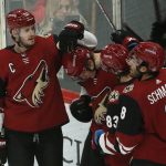Arizona Coyotes left wing Christian Dvorak (18) celebrates with Oliver Ekman-Larsson (23), Conor Garland (83) and Nick Schmaltz (8) after scoring a goal against the Nashville Predators in the first period during an NHL hockey game, Thursday, Oct. 17, 2019, in Glendale, Ariz. (AP Photo/Rick Scuteri)
