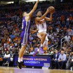 Phoenix Suns guard Devin Booker (1) drives past Sacramento Kings guard Bogdan Bogdanovic during the second half of an NBA basketball game Wednesday, Oct. 23, 2019, in Phoenix. (AP Photo/Rick Scuteri)