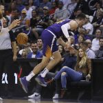 Phoenix Suns forward Frank Kaminsky, right, saves the ball to Suns center Aron Baynes, left, during the first half of a basketball game against the LA Clippers Saturday, Oct. 26, 2019, in Phoenix. (AP Photo/Ross D. Franklin)