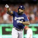 Milwaukee Brewers' Eric Thames gestures after hitting a solo home run during the second inning of a National League wild card baseball game against the Washington Nationals at Nationals Park, Tuesday, Oct. 1, 2019, in Washington. (AP Photo/Andrew Harnik)