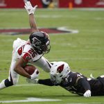 Atlanta Falcons running back Ito Smith (25) is hit by Arizona Cardinals cornerback Byron Murphy (33) during the first half of an NFL football game, Sunday, Oct. 13, 2019, in Glendale, Ariz. (AP Photo/Ross D. Franklin)