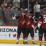 Arizona Coyotes defenseman Jakob Chychrun (6) celebrates with Conor Garland (83) and Carl Soderberg (34) after scoring a goal against the Nashville Predators during the second period of an NHL hockey game Thursday, Oct. 17, 2019, in Glendale, Ariz. (AP Photo/Rick Scuteri)