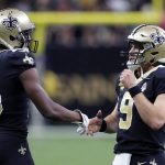 New Orleans Saints quarterback Drew Brees (9) greets New Orleans Saints wide receiver Michael Thomas (13) after a touchdown in the second half of an NFL football game against the Arizona Cardinals in New Orleans, Sunday, Oct. 27, 2019. (AP Photo/Bill Feig)