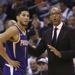 Phoenix Suns head coach Monty Williams, right, talks with Suns guard Devin Booker (1) during the second half of a basketball game against the LA Clippers Saturday, Oct. 26, 2019, in Phoenix. The Suns defeated the Clippers 130-122. (AP Photo/Ross D. Franklin)