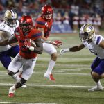 Arizona running back JJ Taylor (21) runs for a first down in the second half during an NCAA college football game against Washington, Saturday, Oct. 12, 2019, in Tucson, Ariz. (AP Photo/Rick Scuteri)